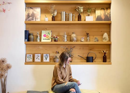 a woman sitting on a table in a coffee shop