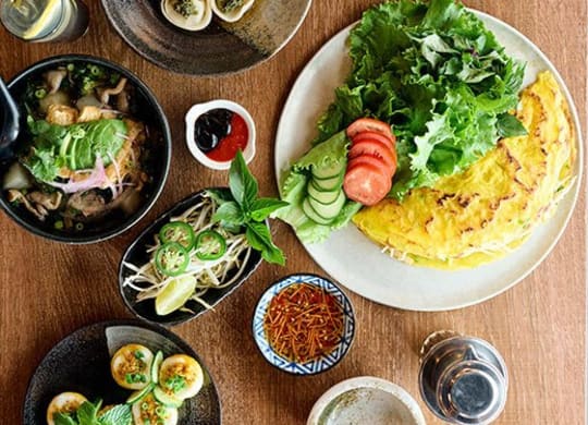 a table with plates of food and bowls of food on it