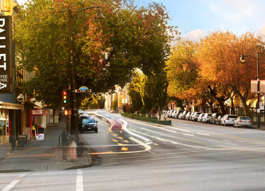 a busy city street with cars driving down it