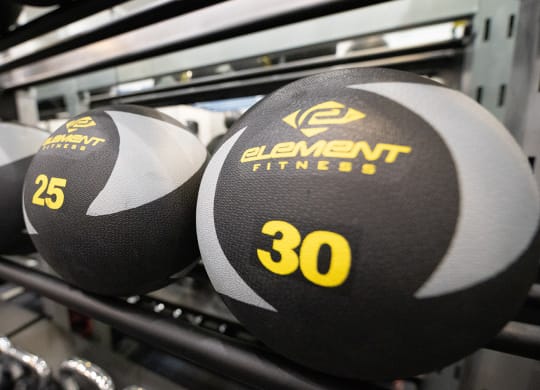 a close up of three dumbbells on a rack at Wynnwood Vinings Atlanta fitness center