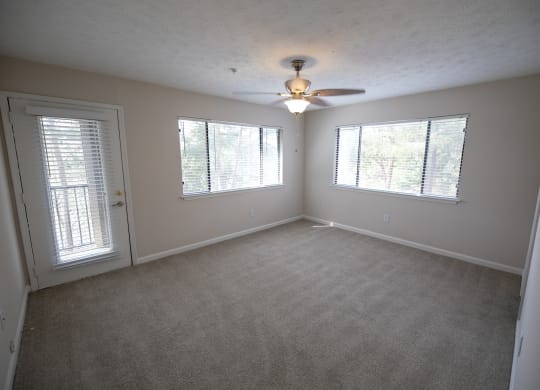 Carpeted bedroom with a ceiling fan at Wynnwood Vinings Atlanta