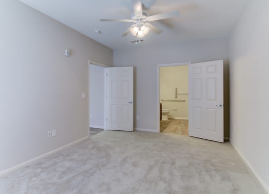 the heights at converse apartments inside bedroom with lighted ceiling fan and light paint
