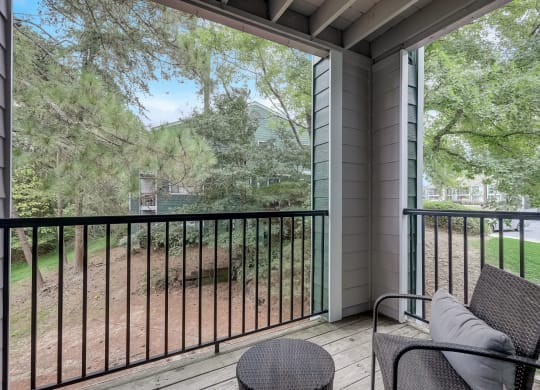 a private balcony with a view of a yard and trees at Wynnwood Vinings Atlanta