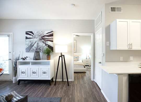 A kitchen with white cabinets and a black dishwasher.