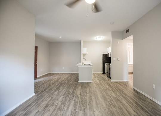A room with a wooden floor and a white counter.