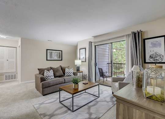 A living room with a couch, a coffee table, and a painting on the wall.