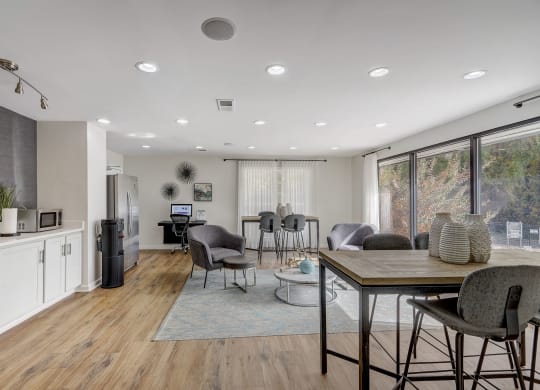 a living room and dining room with a table and chairs