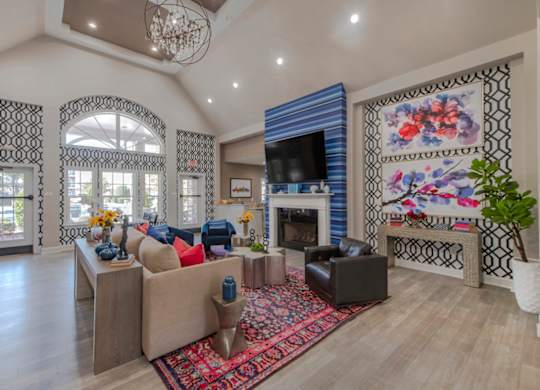 A living room with a fireplace and a large rug.