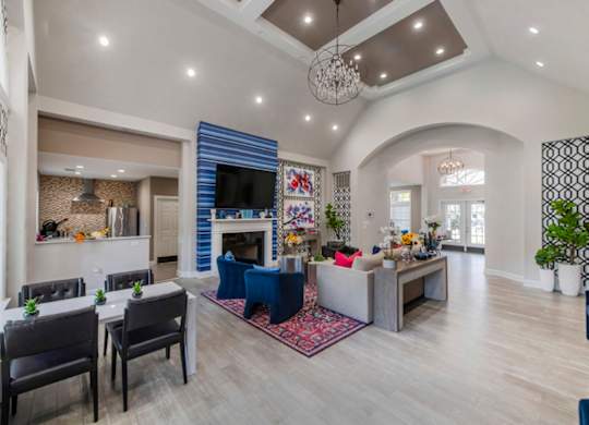 A living room with a fireplace and a dining table.