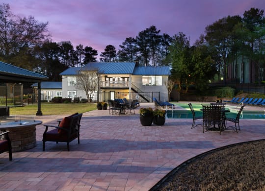 a backyard with a paver patio and a swimming pool
