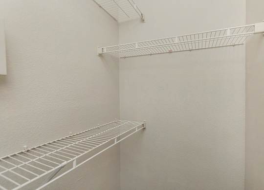 Empty white shelves in a room.