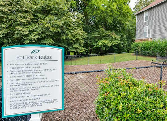 a dog park with a sign that says pet park rules at Canopy at Baybrook apartments in Charlotte NC