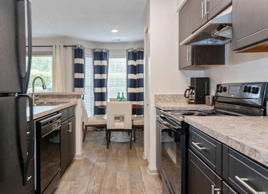 a kitchen and dining area at Canopy at Baybrook apartments in South Charlotte