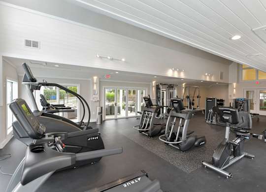 a gym with cardio machines and other exercise equipment at the estates at johnston crossing