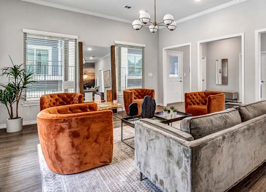 Leasing office at Sendero Ridge Apartments Kerrville with couches and chairs and a table