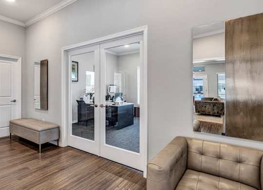 a club room with a couch and a door to a office