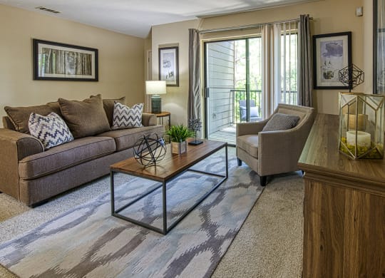 a living room with a couch chair and coffee table at Wynnwood Vinings