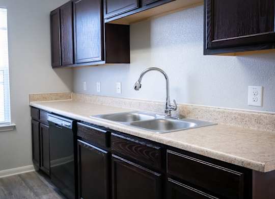 A kitchen with a sink and cabinets.