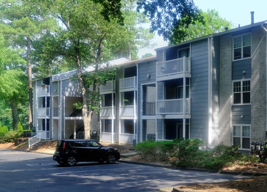 a car parked in front of an apartment building
