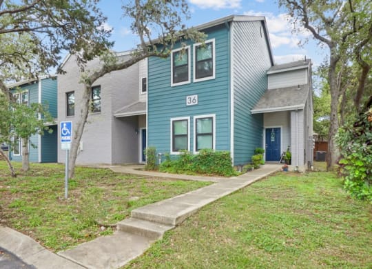 a blue house with a blue door and gray and white siding