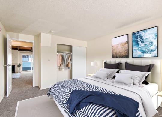 A renovated bedroom with a large bed and a Wall Art at  Foster Creek apartments in Tukwila, WA
