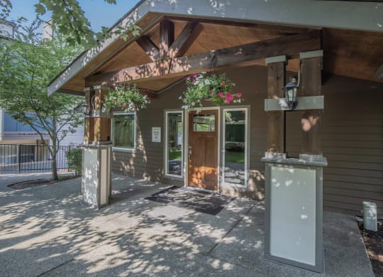 A shaded walkway leading up to the entrance of the renovated leasing office at Foster Creek apartments