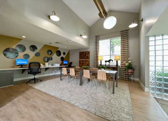 a large living room with a table and chairs and a window
