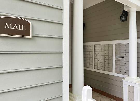 a mail room with mailboxes on the side of a building at Lexington Farms apartments