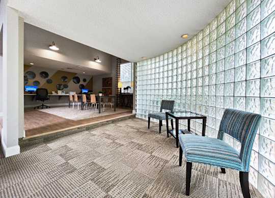 a room with office chairs and a table and a lobby at Lexington Farms apartments leasing office