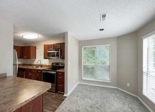 an empty kitchen with a large window and