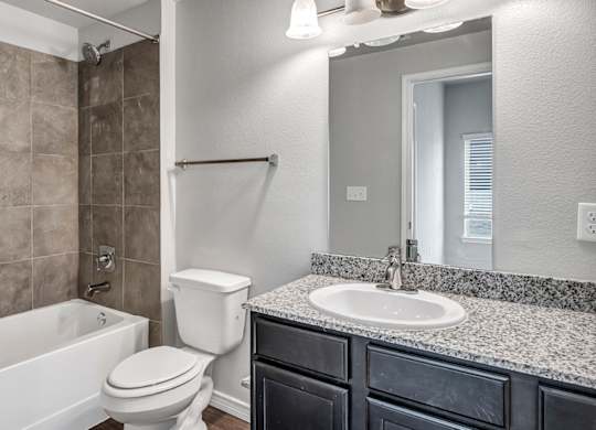 a bathroom with a sink toilet and a tub
