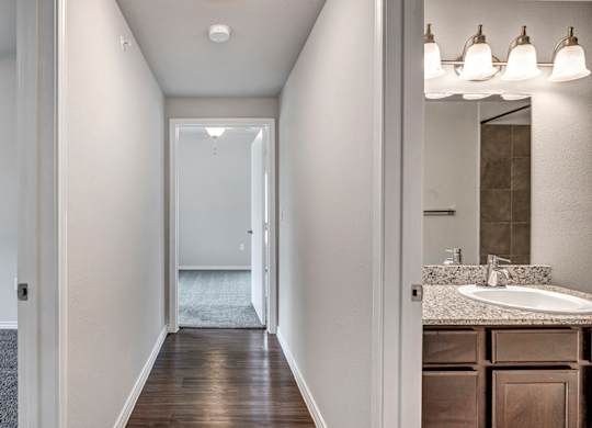 the retreat apartments renovated bathroom with sink and mirror