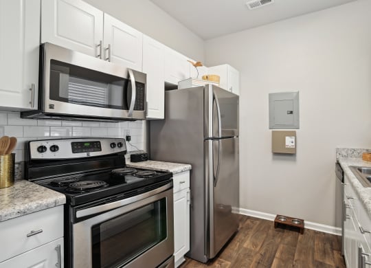 a kitchen with stainless steel appliances and white cabinets