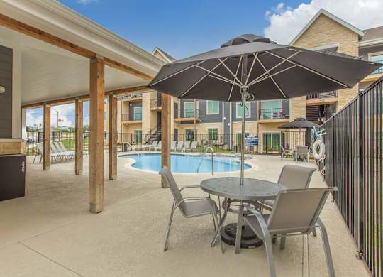 Poolside Pavilion and BBQ grill area at  Sendero Ridge Apartments Kerrville