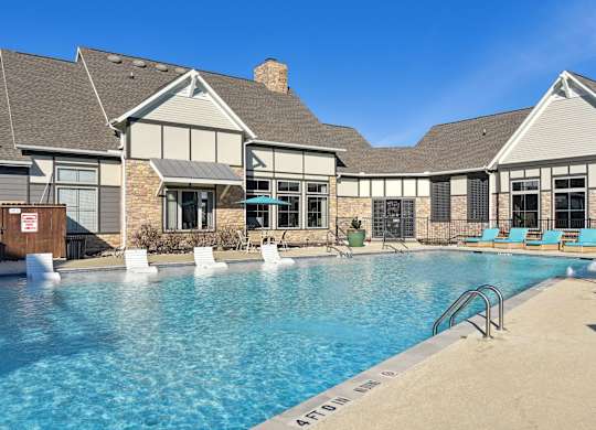 the preserve at ballantyne commons pool and building with lounge chairs