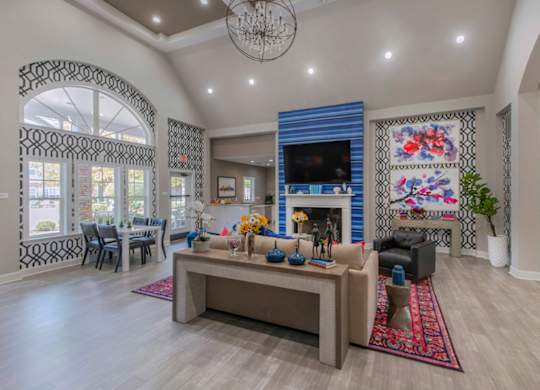 A living room with a fireplace and a large rug.