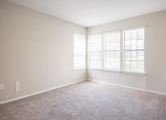 One Bedroom Apartments in Duluth, GA - The Eclipse - Bedroom with Plush Carpet Flooring and Windows with Blinds