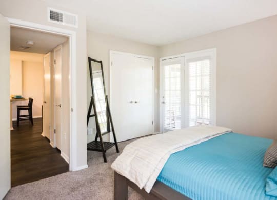 a bedroom with a bed and a mirror