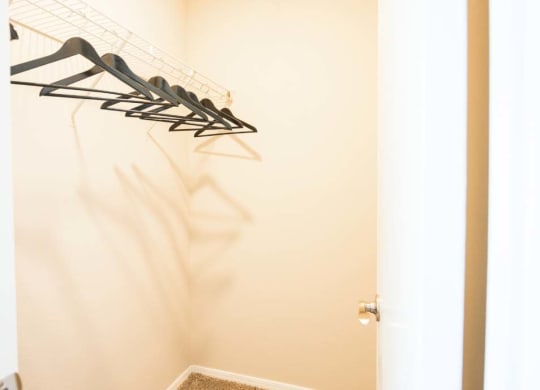 a closet with some clothes hangers on the wall