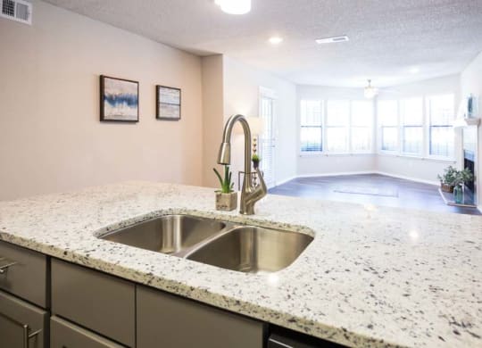 Kitchen Sink with living room in the background at Eclipse Apartments in Duluth