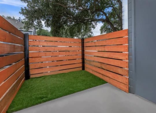 An enclosed patio with a new wooden fence at apex apartments in san antonio