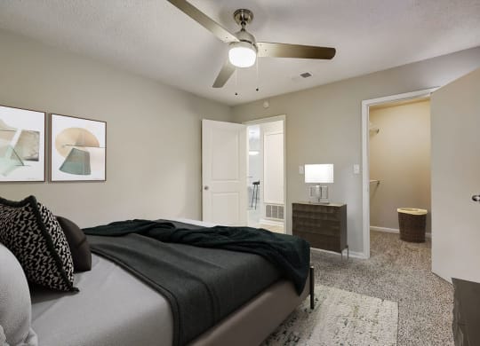 a bedroom with a bed and a ceiling fan