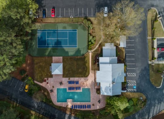 an aerial view of a house with a tennis court and tennis court
