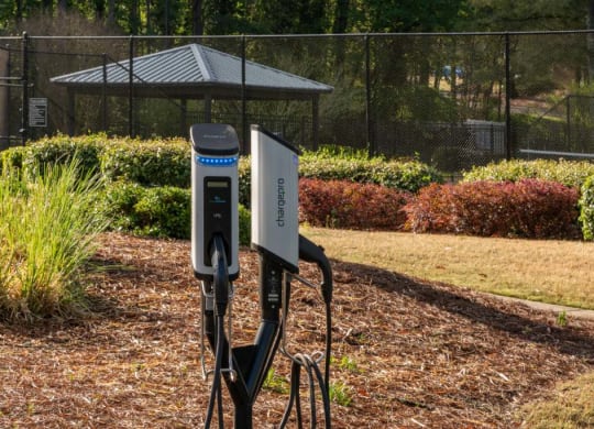 Veridian at Sandy Springs apartments power station in a park with a fence and a gazebo in the background