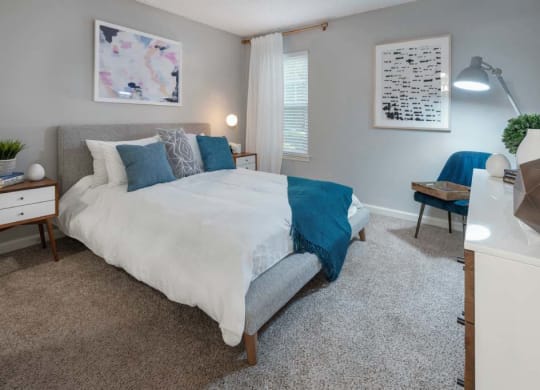 Veridian at Sandy Springs apartments interior bedroom with a bed and a desk with a chair