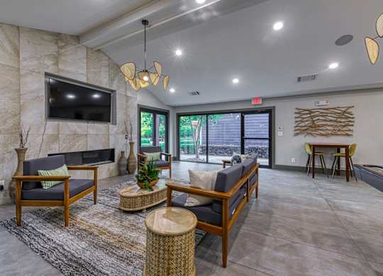 A living room with a flat screen TV mounted on a stone wall.