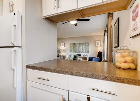A kitchen with white appliances and cabinets at The Ranch at Bear Creek Apartments, Colorado, 80227