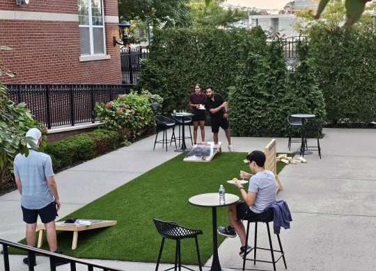 Residents enjoying games in the Courtyard at West 130 , West Hemopstead, NY