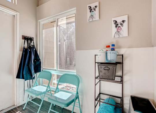 A room with a chair, a table, and a window at The Ranch at Bear Creek Apartments, Lakewood