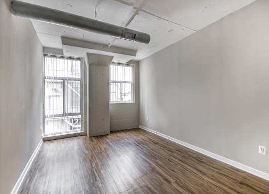 A room with wooden floors and white walls.
